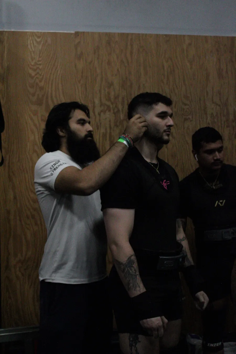 Coach Khush giving a lifter final cues before a platform attempt