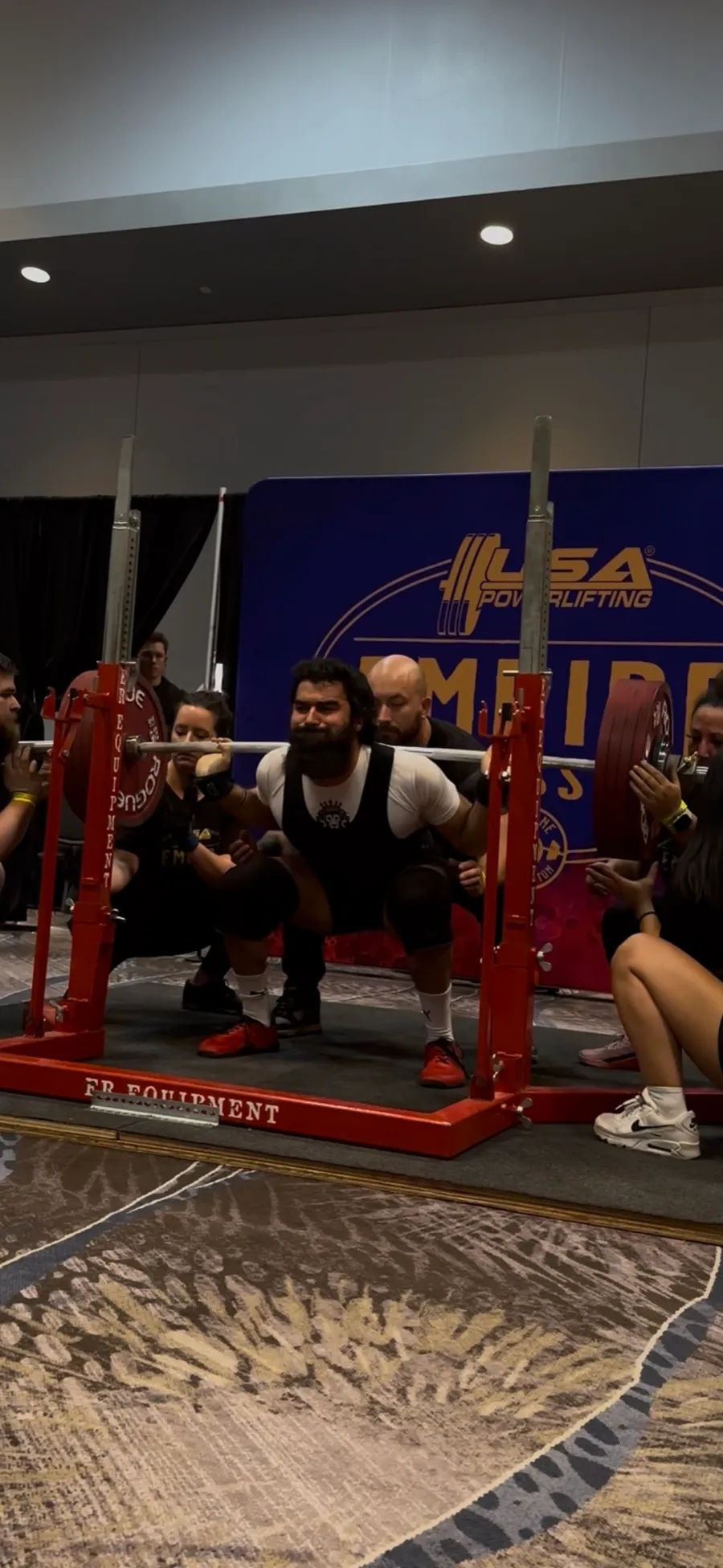 Coach Khush squatting at a USA Powerlifting meet